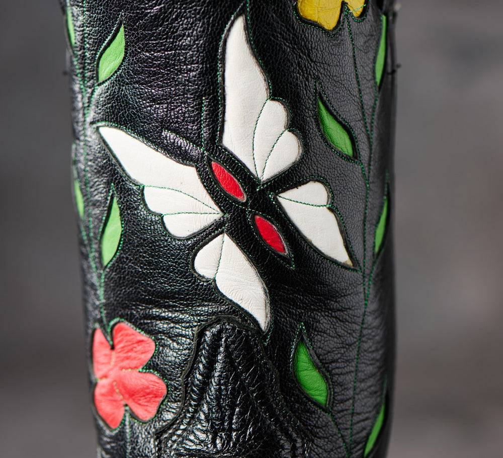 Close-up of floral inlays on a black cowboy boot in Western Horseman.