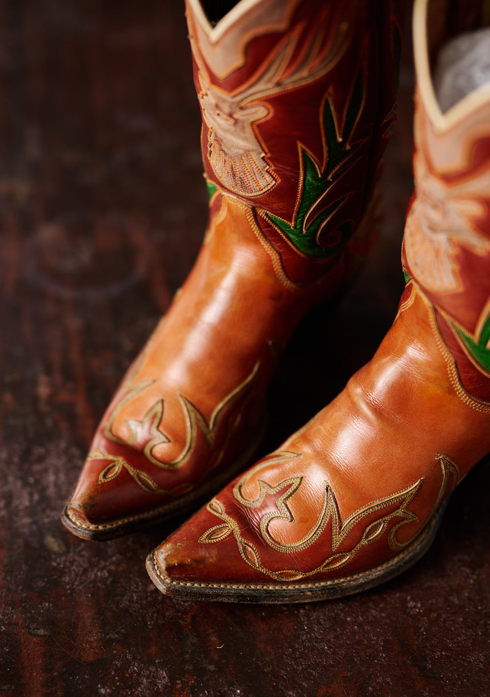 Brown cowboy boots with floral inlays, pictured in Western Horseman.