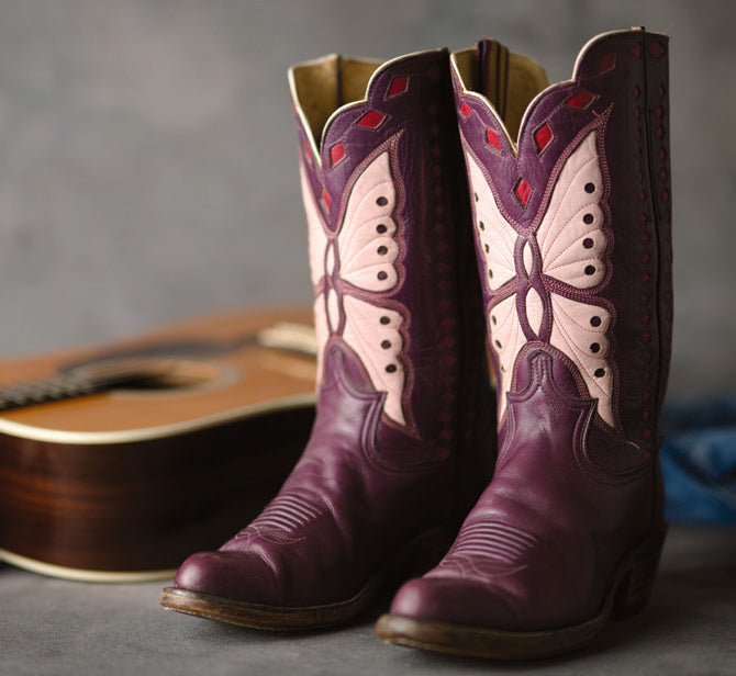 Purple cowboy boots with contrasting inlays, pictured in Western Horseman.